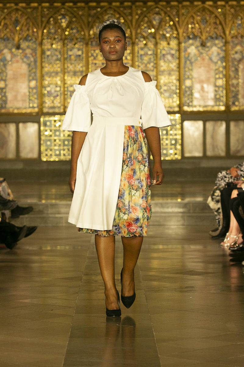 A-line dress with cut shoulders and removable skirt.