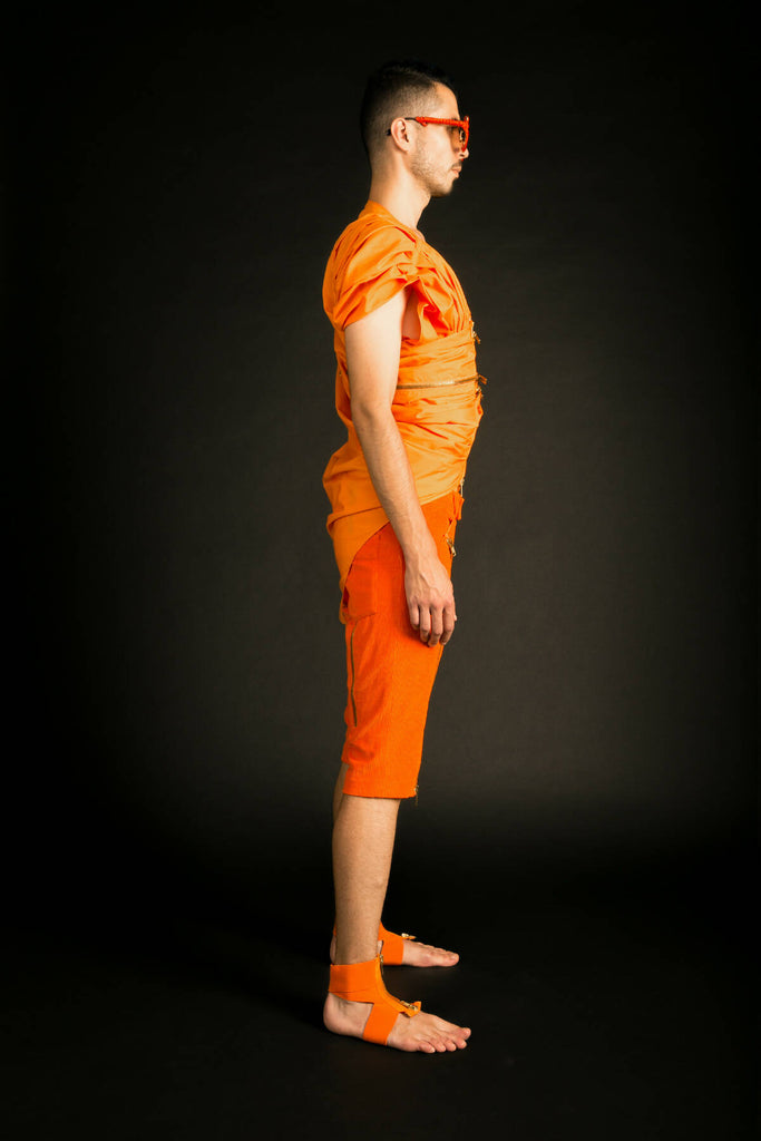 A draped sleeveless shirt.